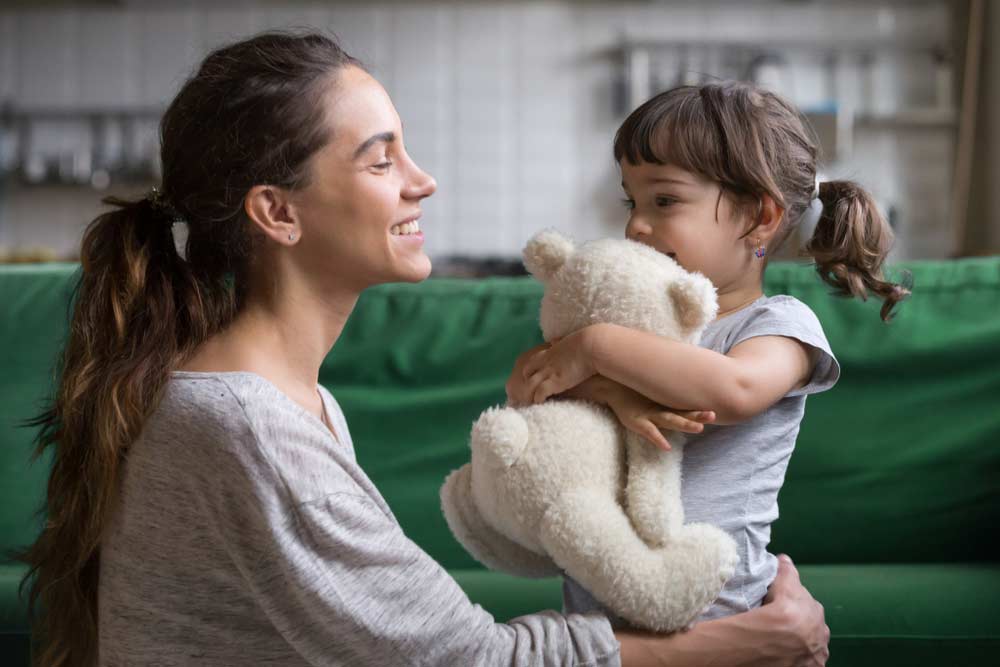 Mother And A Little Girl Hugging A Teddy Bear Toy